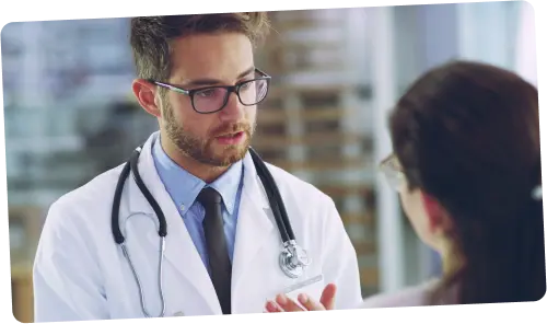 Locum tenens doctor consulting with a patient or nurse in a hospital hallway – explore diverse locum tenens staffing solutions with xLocums.